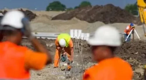 workers carrying out a construction site risk assessment.