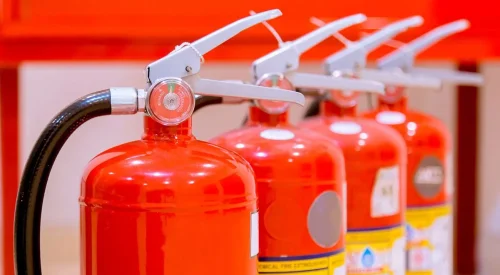 commercial fire extinguishers installed in an office